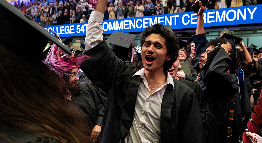 SUNY-Purchase-Commencement-2026 Student in graduation regalia with fist in air celebrating commencement.