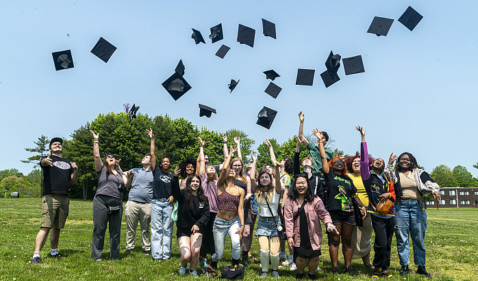 Students throw grad caps in the air