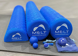 foam rollers and balls on a yoga matt