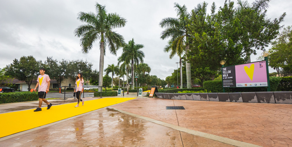 Participants walk on the The Yellow Walk performance created by Kate Gilmore