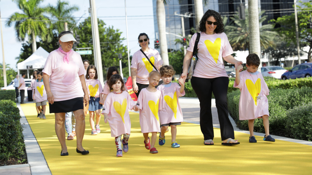 Participants walk on the The Yellow Walk performance created by Kate Gilmore