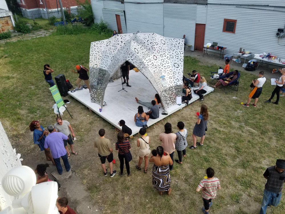 People on the site of the American Riad Project in Detroit enjoy the prototype.