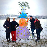 Students show off their colorful snow person on the Great Lawn.