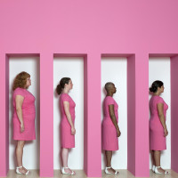 Kate Gilmore, Wall Bearer, 2011. Performance and installation at the Weatherspoon Art Museum, Greensboro, NC (Women in pink dresses stand...