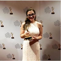Rachel Weiss '16 holds her NY Emmy