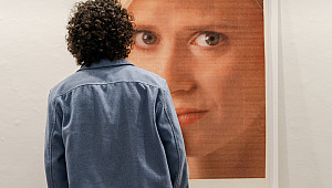 A gallery visitor looking at art