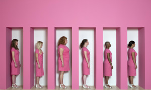 Kate Gilmore, Wall Bearer, 2011. Performance and installation at the Weatherspoon Art Museum, Greensboro, NC (Women in pink dresses stand...
