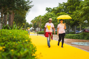 Participants walk on the The Yellow Walk performance created by Kate Gilmore