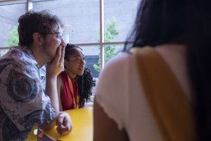 Students talk at a table.