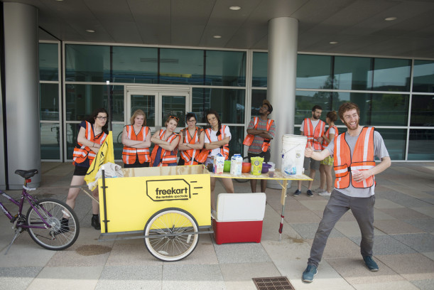 New Media Tactical Practical class hand out free refreshments from their freekart project.