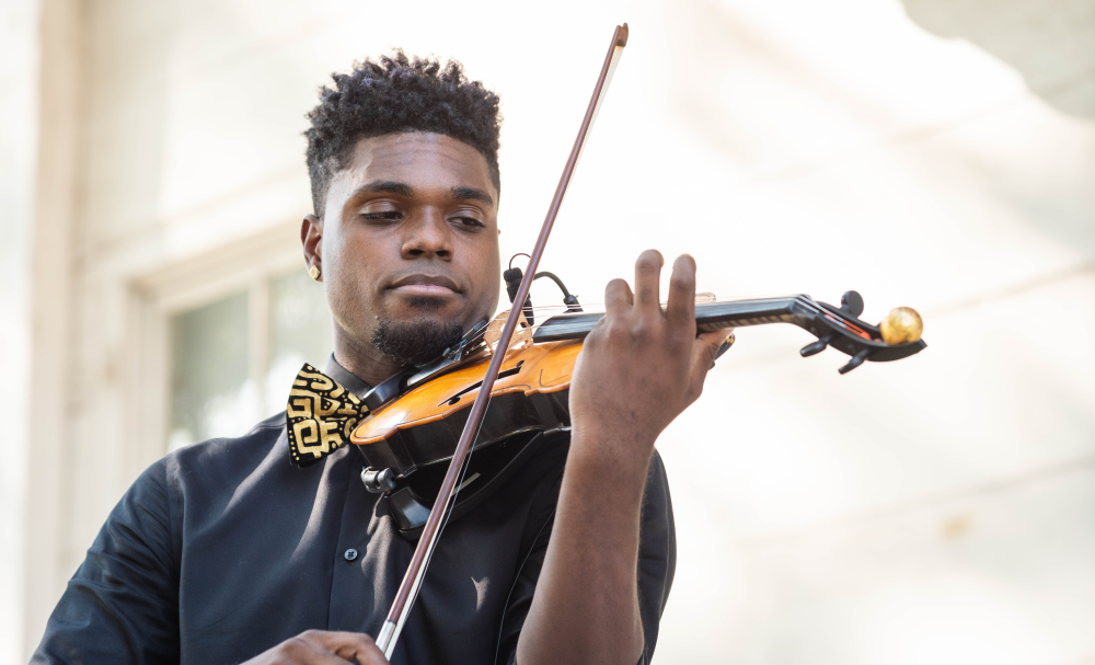 Black man playing a violin