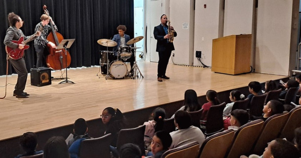 Elementary School children enjoy a performance featuring Purchase Jazz students and Professor Dav...