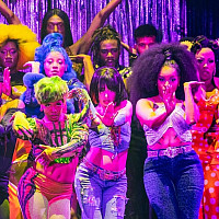 14 actors on stage dressed in neon striking vogue poses