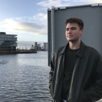 Student Brendan Rose standing by Water looking ahead