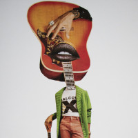 Woman in green sweater with guitar for a head.