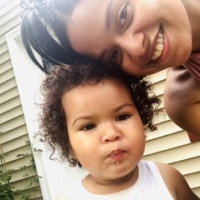 Student Pamela Alberto next to a baby