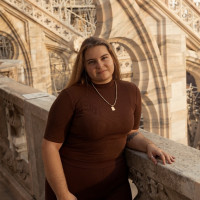 Student Tina Pizzuti standing by a marble banister