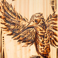 Wood carving of a bird in flight.