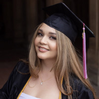 Student Kaitlyn Fikaris in Graduation cap and gown