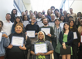 2023 Symposium participants proudly display certificates.