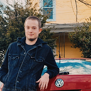 Student Dylan McKenna leaning against a car