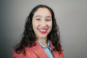 Potrait photo of Caroline Jimenez in pink blazer smiling