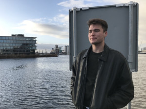 Student Brendan Rose standing by Water looking ahead