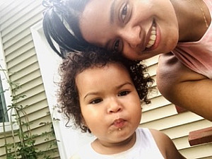 Student Pamela Alberto next to a baby