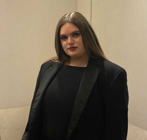 Student Morgan Robinson in a black shirt and dress jacket.