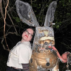 Student Gaia Cooper standing next to an art installation