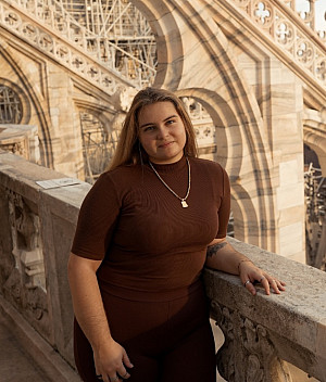 Student Tina Pizzuti standing by a marble banister