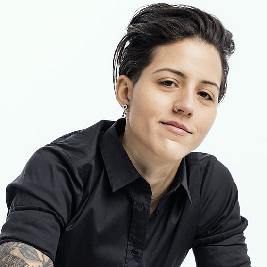 Marissa LaRocca '09 sits in a white chair with a white background