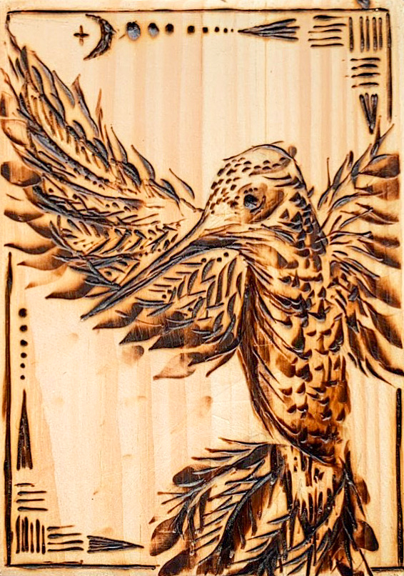 Wood carving of a bird in flight.