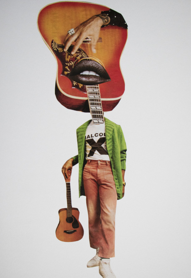 Woman in green sweater with guitar for a head. 