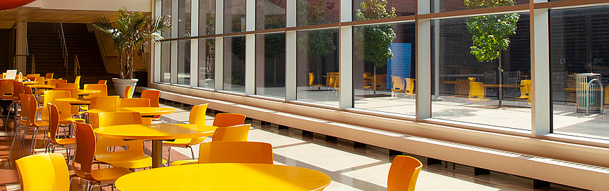 Humanities Lobby with Yellow chairs and tables.