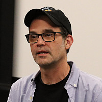 Andrew Buckland seated at front of the screening room.