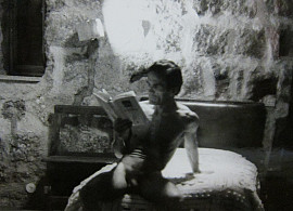 Still from Pasolini's Last Words (Cathy Lee Crane, 2012) featuring Pasolini reclining and reading a book