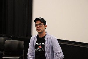 Andrew Buckland seated at front of the screening room.