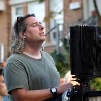 Photographer Gregory Crewdson '85 setting up a shot with his 8x10 camera on location in Pittsfield, Massachusetts at the corner of S...