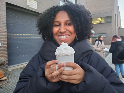Student enjoys a cup of cocoa at the A+D Hot Cocoa and Marshmallow Roast Feb 2022