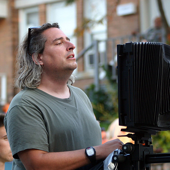 Photographer Gregory Crewdson '85 setting up a shot with his 8x10 camera on location in Pittsfield, Massachusetts at the corner of S...