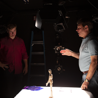 David Grill '86 and student look at stage model