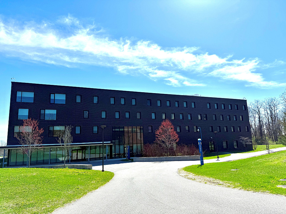 A brick building with several trees out front.