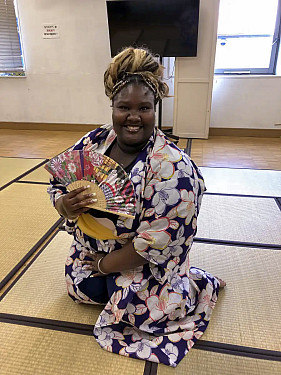Chanelle McKenzie kneels wearing traditional Japanese yukata.