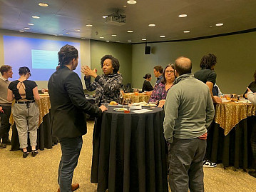 Students, alumni, and staff practicing networking.  