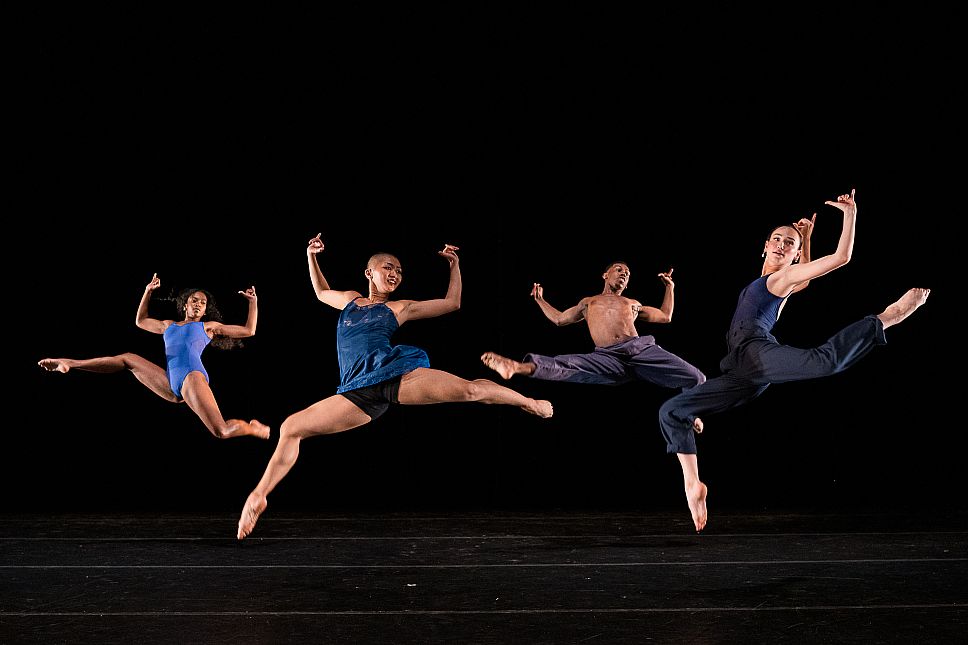 Dancers leaping on stage