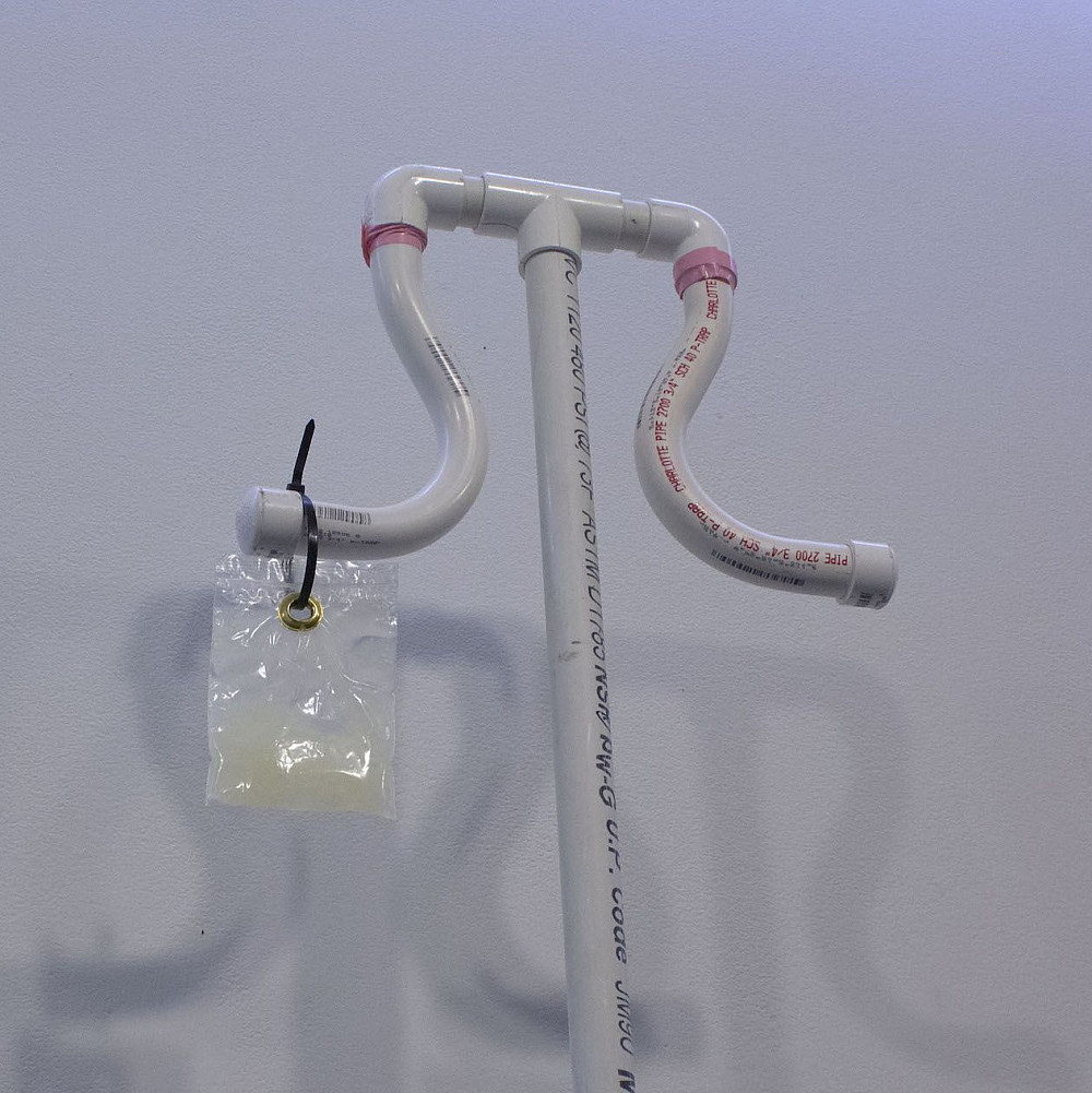 Liv Cocozza, Oil (detail), 2020, PVC, electrical tape, casters, zip tie, oil, dental dam package,...