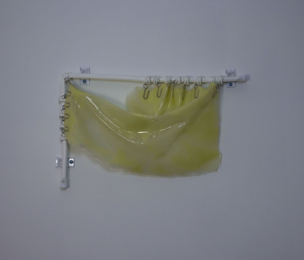Liv Cocozza, Untitled (Yellow), 2020, Silicone, plastic curtain rod, screws, brackets, metal hook...