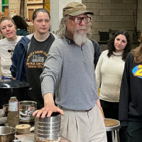 Ken Weeks demonstrates birchbark canoe techniques to students in Bradley Pitts' Land Foundations class.