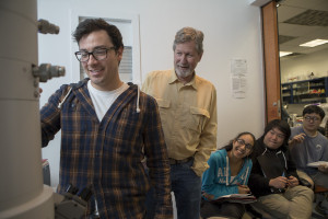 Professor Jan Factor works with a student on electron microscope